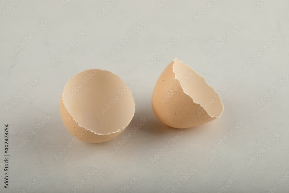 Broken brown eggshell on a marble background Broken brown eggshell on a marble background