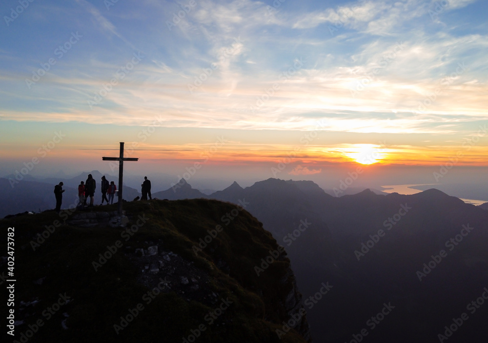 Awesome sunset with mountains and a cross