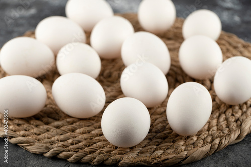 Some of white raw chicken eggs on a sackcloth
