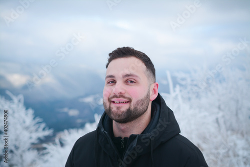 Attractive guy portrait in winter on the street