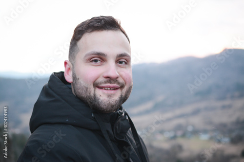 Attractive guy portrait in winter on the street