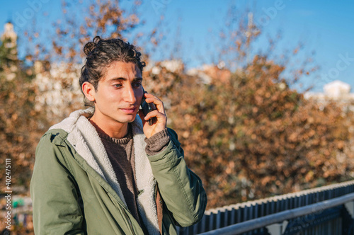 Handsome Young Man With Incredulous Expression Talking to the Phone in a Bridge © Eduard Borja