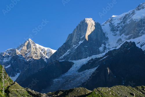 Twin tall pointed rocky peaks named 'Kedar Peak' and 'Kedar Dome' in Western Himalayan Mountain Range, covered with snow and glaciers, as viewed from Kedarnath Temple, Garhwal, in Uttarkhand, India.   © njaganath