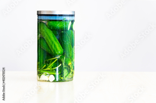 glass jar with pickled cucumbers