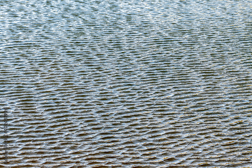 Small ripples on a lake. The wind causes smaller ripples on the main ripples.