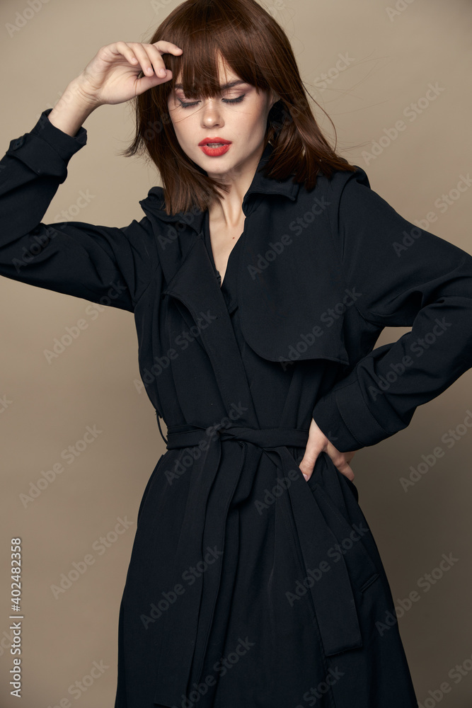 Beautiful woman classic coat charming smile posing on an isolated background Beautiful woman classic coat charming smile posing on an isolated background