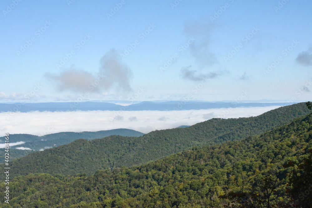 View of the blue ridge mountains and clouds over the valley as seen from Shenandoah National Park