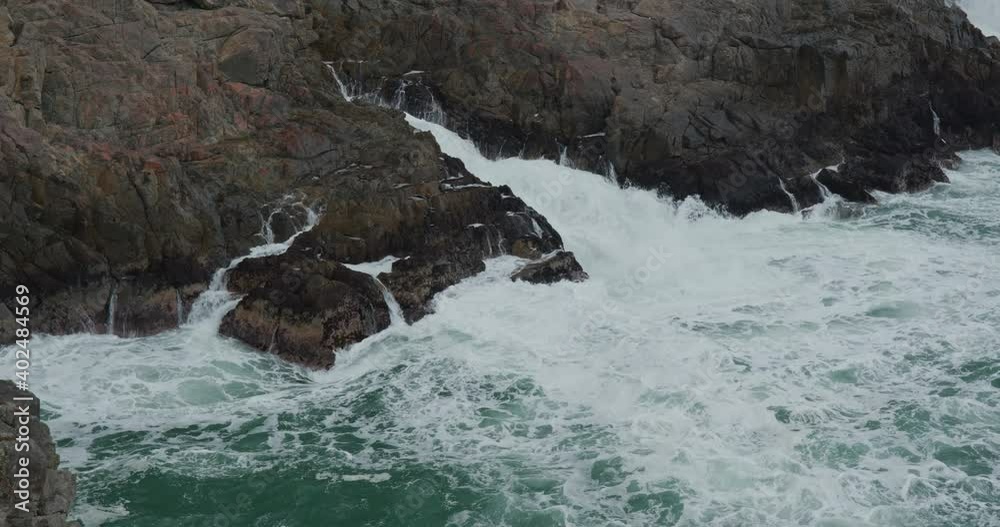 Ocean waves splash against rock on island Ocean waves splash against rock on island