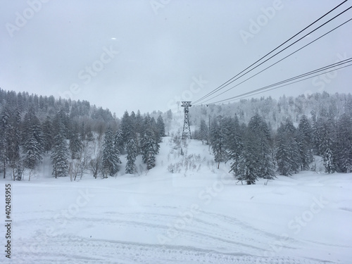 Landscape view of the aerial tramway at a ski resort in Japan on a cloudy winter day