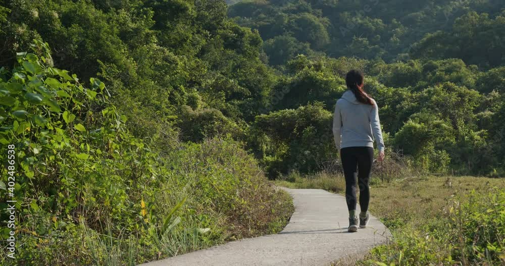 Woman walk in the hiking trail
