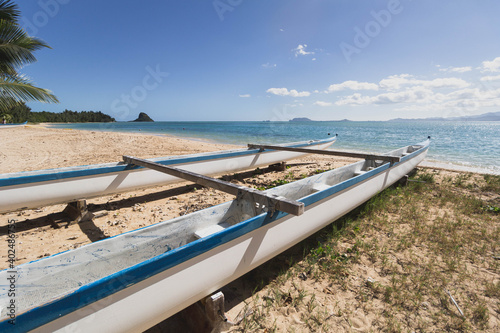 Boat on beach in Hawaii with clear skies, ready for outdoor adventure