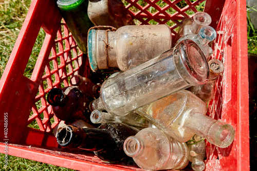 Plastic Crate of Old, Dusty Glass Bottles, Horizontal View photo