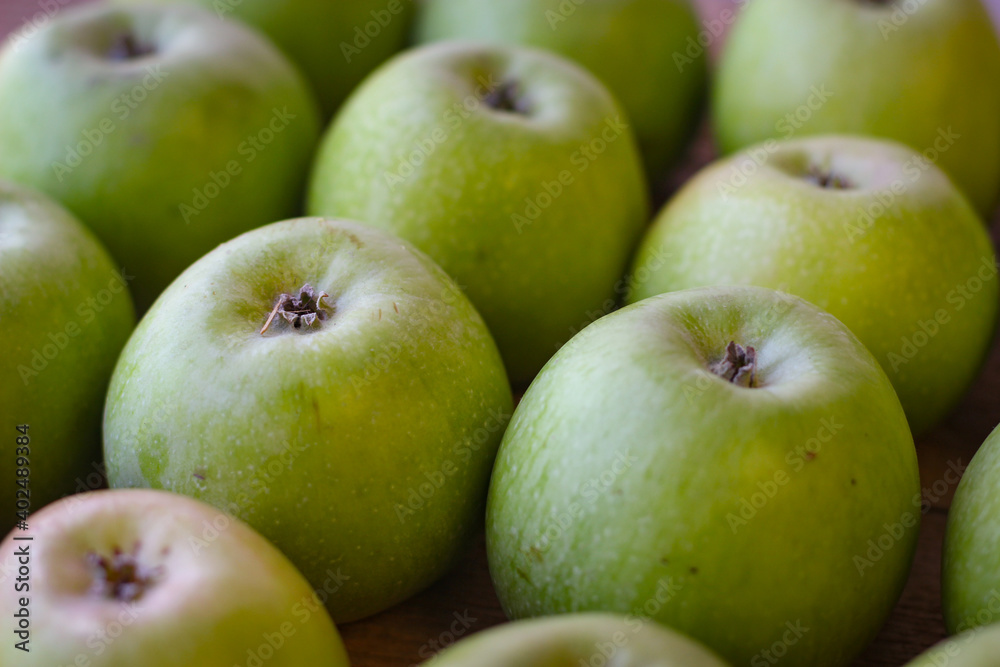 Apples stand on a wooden surface Apples stand on a wooden surface