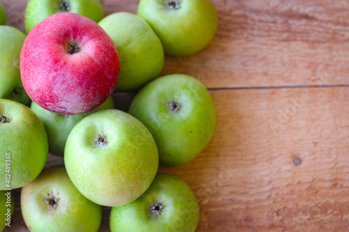 Apples stand on a wooden surface