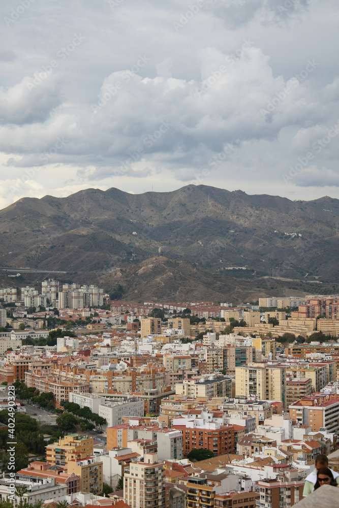 Malaga, Spain - An aerial view of Malaga's skyline with a cloudy sky as a backdrop.  Image has copy space.