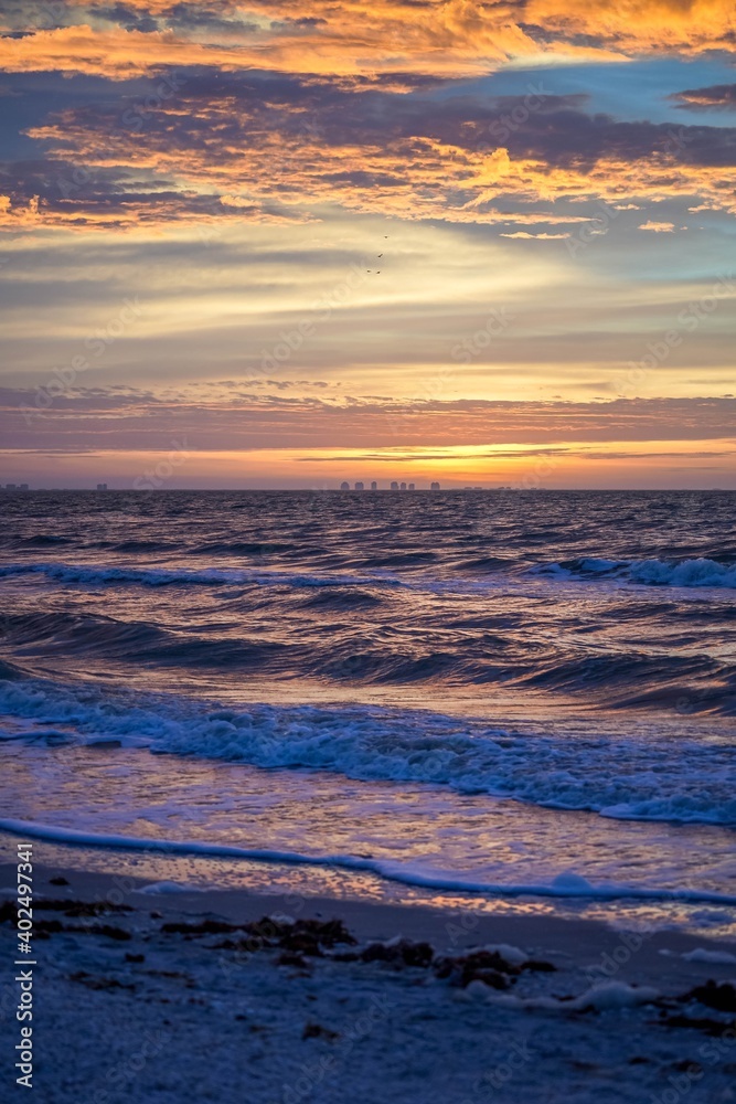 Brilliant colorful sunrise over ocean waves along the beach at Sanibel Island, Florida before Hurricane Ian