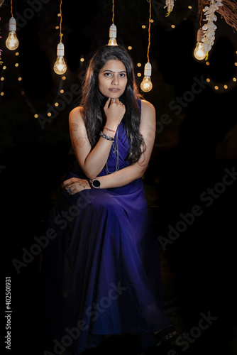 woman in a dress looking at the camera 