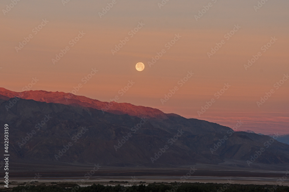 Moon setting at sunrise, Death Valley, California, USA