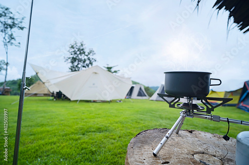 Cooking instant noodle with boiling in pitch pot during camping photo