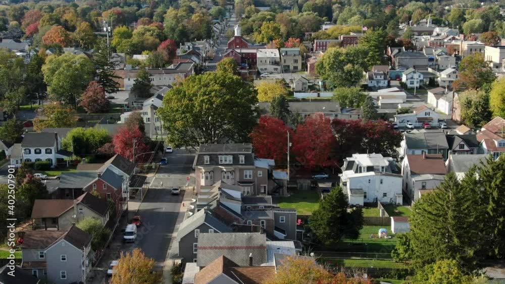 Aerial establishing shot of city with colorful autumn fall foliage. Town in America truck shot in quaint neighborhood. Aerial establishing shot of city with colorful autumn fall foliage. Town in America truck shot in quaint neighborhood.