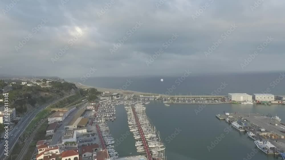 Isolated white balloon flying away over Arenys de Mar. Aerial circling Isolated white balloon flying away over Arenys de Mar. Aerial circling