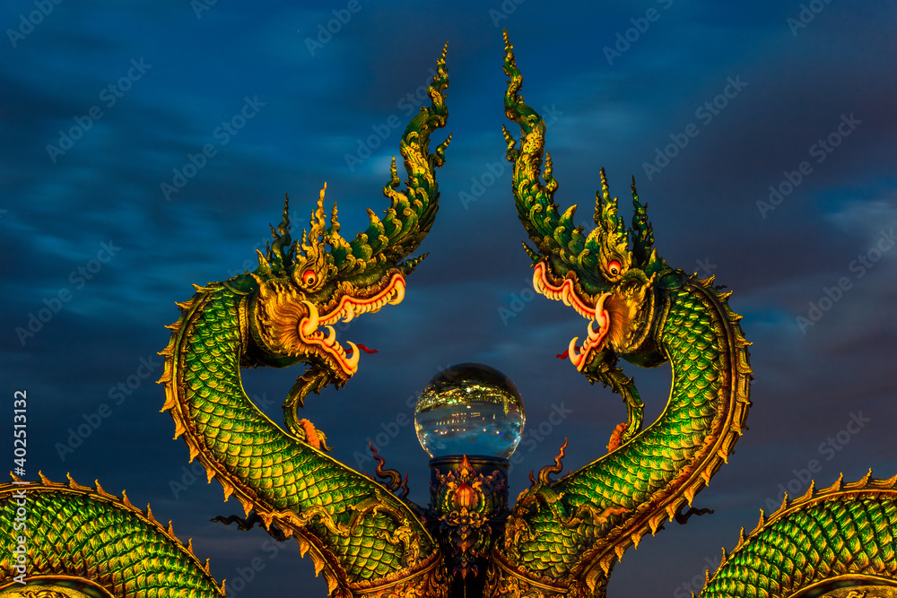 Background of Thailand's Chonburi religious attractions (Wat Khao Phra Khru viewpoint), with beautiful Buddha and Phaya Naga statues, tourists always come to make merit and take pictures at night.