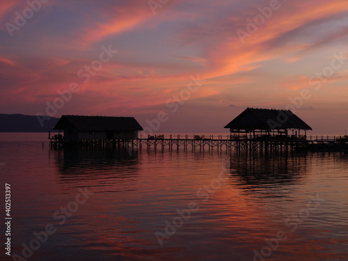sunset raja ampat pier and houses tropical scenery photo