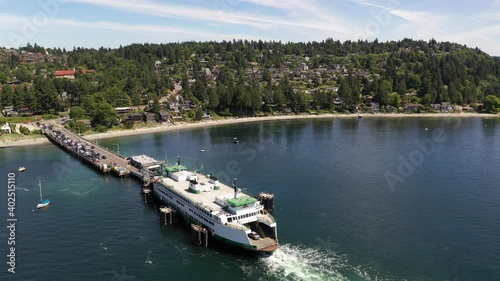 Drone - aerial tracking shot of the docked ferry at the ferry terminal with cars loading and unloading in Fountleroy, near Lincoln Park, Endolyne, Gatewood and Seattle, King County Washington photo