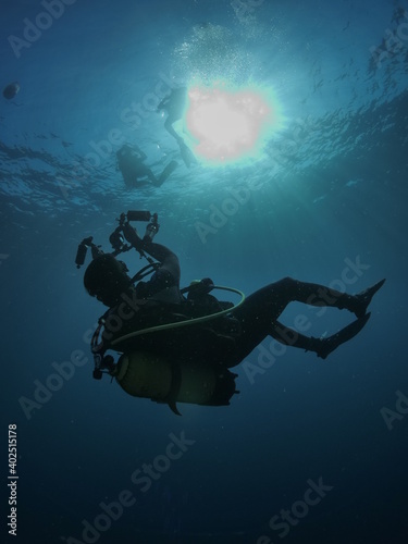 scuba diver photographer underwater taking photos blue ocean scenery of scubadiver with  hobby © underocean