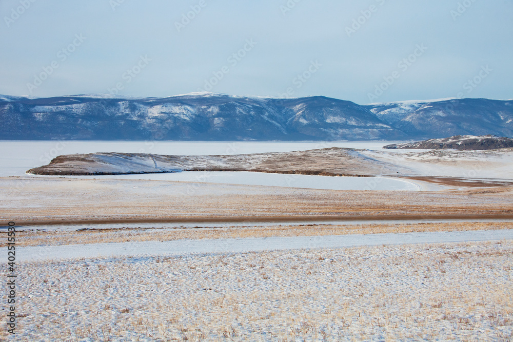 Grass and snow on Olkhon Island. Winter landscape