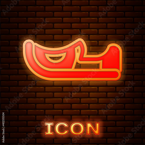 Glowing neon Traditional indian shoes icon isolated on brick wall background. Vector.