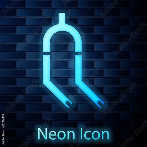 Glowing neon Bicycle suspension fork icon isolated on brick wall background. Sport transportation spare part steering wheel. Vector.