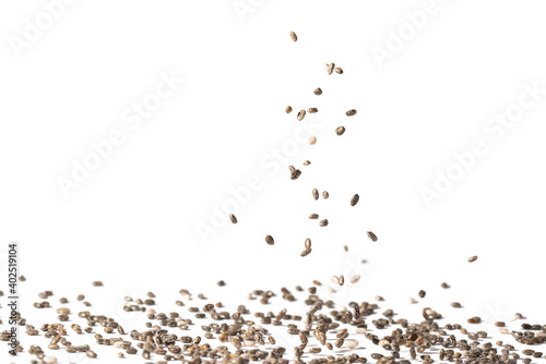 Close up of chia seeds falling and landing spread with white background