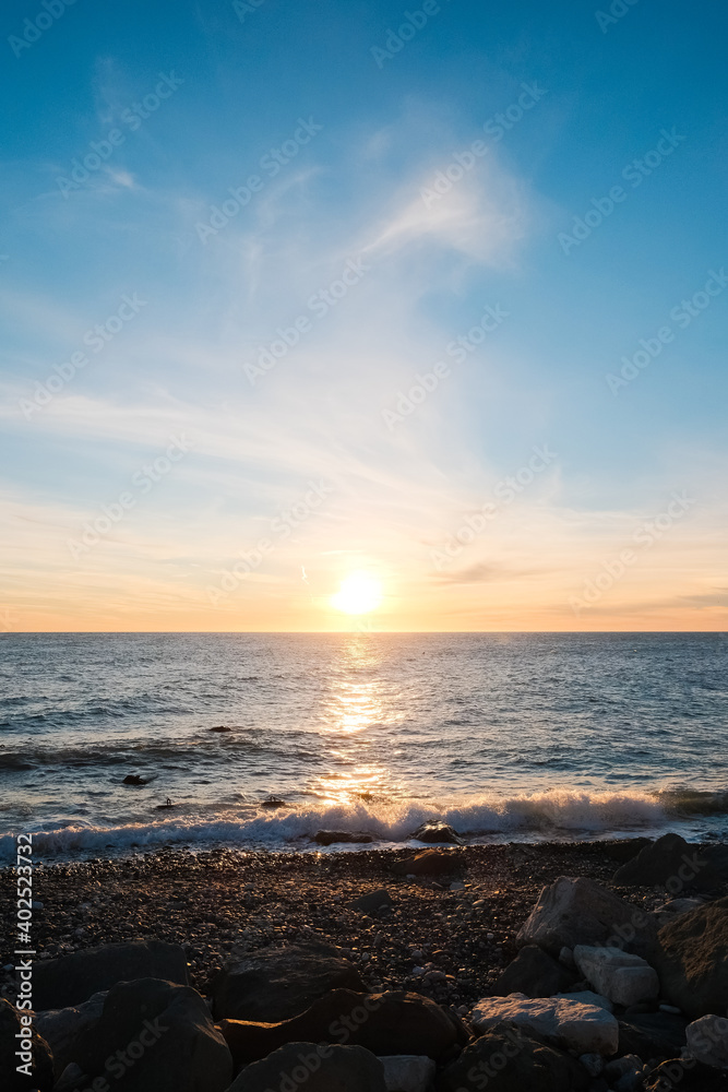 Obraz premium Seascape. Wild pebble beach at sunset.