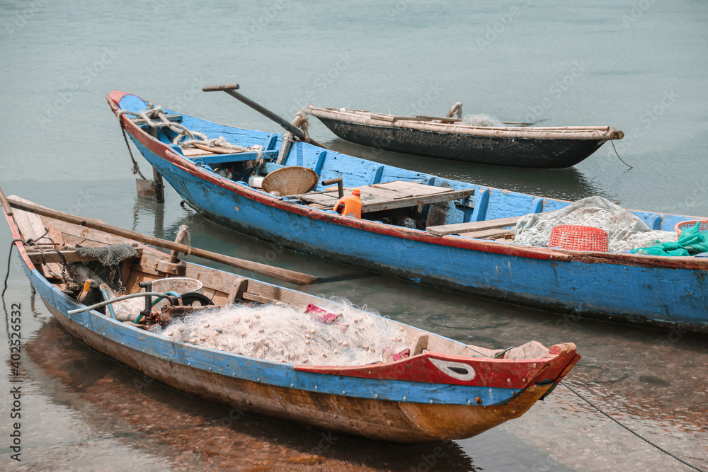 Traditional Vietnamese fishing boats carrying nets and moored at Duy Vinh Fishing Village in Vietnam