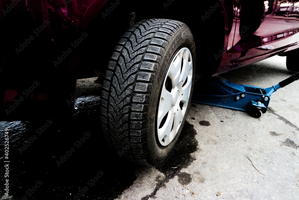 Winter Tires Are Very Safe. Changing Tires With Winter Tires In A Garage. Winter Tires Are Very Safe. Changing Tires With Winter Tires In A Garage.
