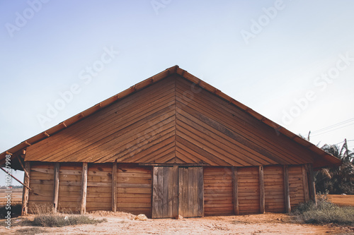 Cinematic scenery of a traditional wooden salt storage house in the salt fields or farm in Kampot, Cambodia