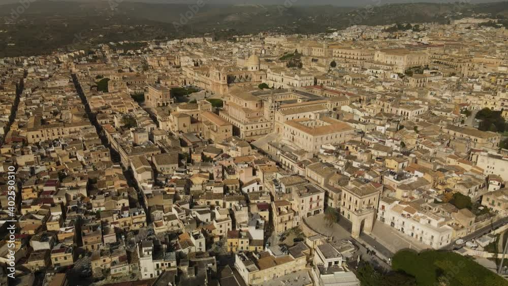 Aerial view above the rooftops. Drone flies above the ancient baroque town Noto, UNESCO world heritage site at sunny day, Sicily, south Italy Aerial view above the rooftops. Drone flies above the ancient baroque town Noto, UNESCO world heritage site at sunny day, Sicily, south Italy