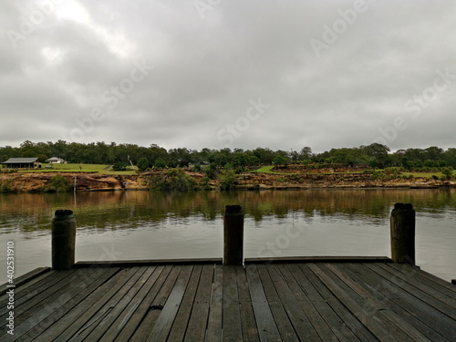 Beautiful view of river with reflections of small hills, trees and clouds on water, Hawkesbury river, Cattai national Park, New South Wales, Australia
 photo