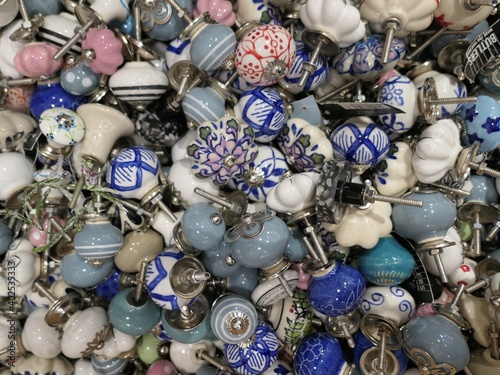 Assortment of Porcelain Cupboard Knobs of Blue, White and Grey  - Closeup of assorted hand-painted blue, white and grey porcelain cabinet pulls.
