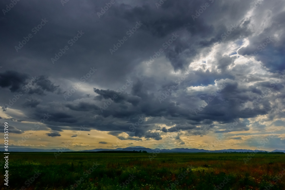 dark rain clouds before rain in a flat landscape