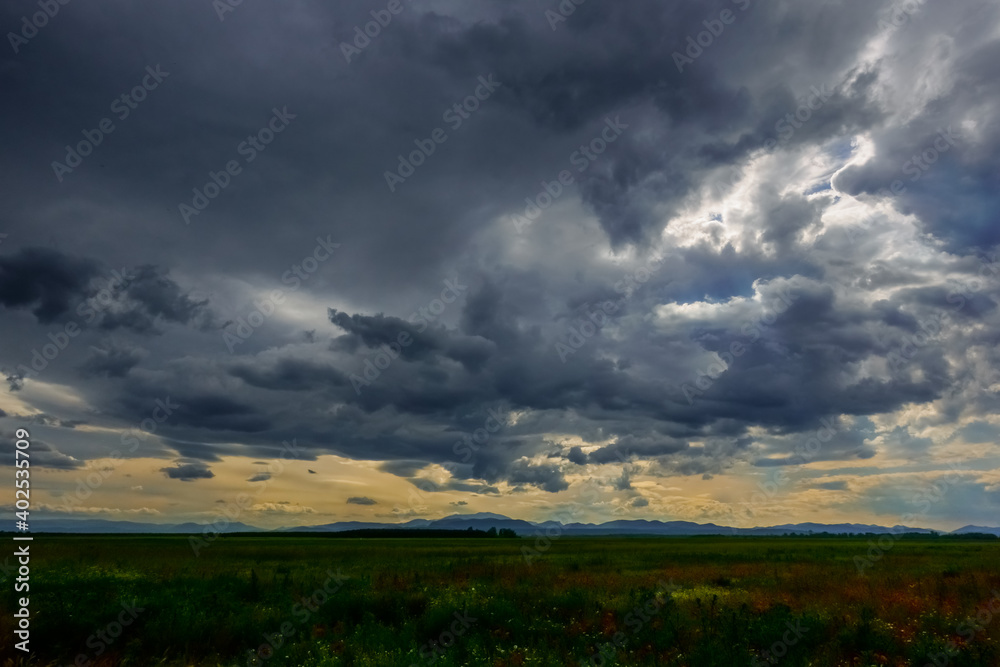 dark rain clouds before rain in a flat landscape dark rain clouds before rain in a flat landscape