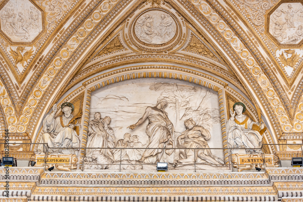 Statues carved on mable wall showing a religious scene in Saint Peter Basilica in the Vatican