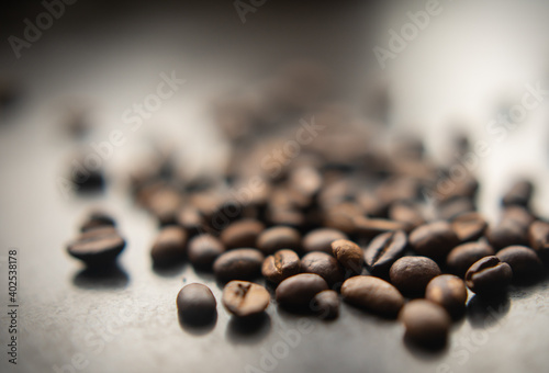 Coffee beans scattered on blurry background