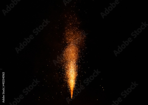 Firecracker sprays a fountain into the night, concept of new year's eve and celebrations
