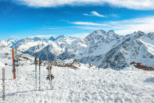 Ski in snow with snow blue winter mountains in clouds. Winter ski resort © Pavlo Vakhrushev