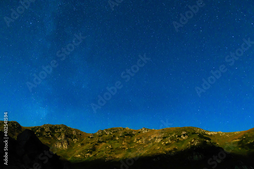 Mountain landscape at night with many stars