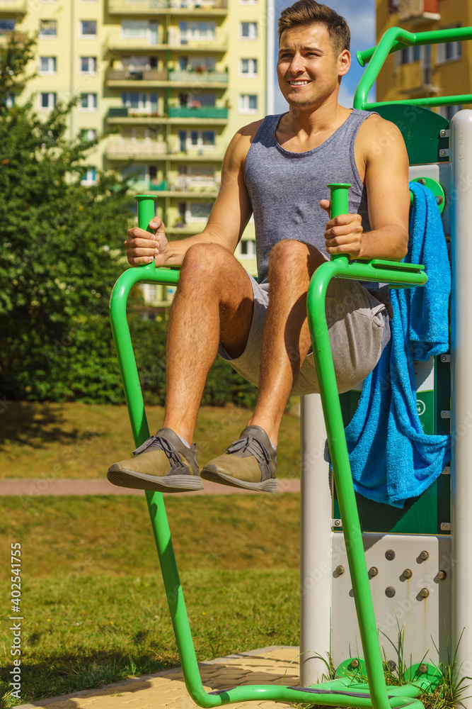 Fototapeta premium Man doing sit ups in outdoor gym