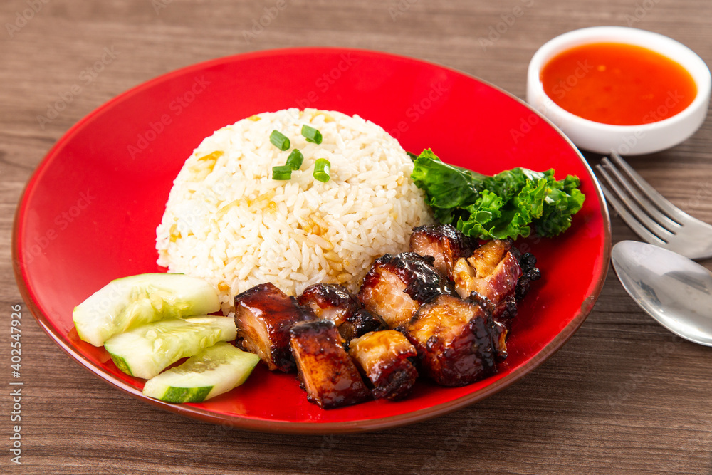 Chinese Sweet Bbq Pork is marinated in a sweet BBQ sauce and served with white rice. Chinese Sweet Bbq Pork is marinated in a sweet BBQ sauce and served with white rice.