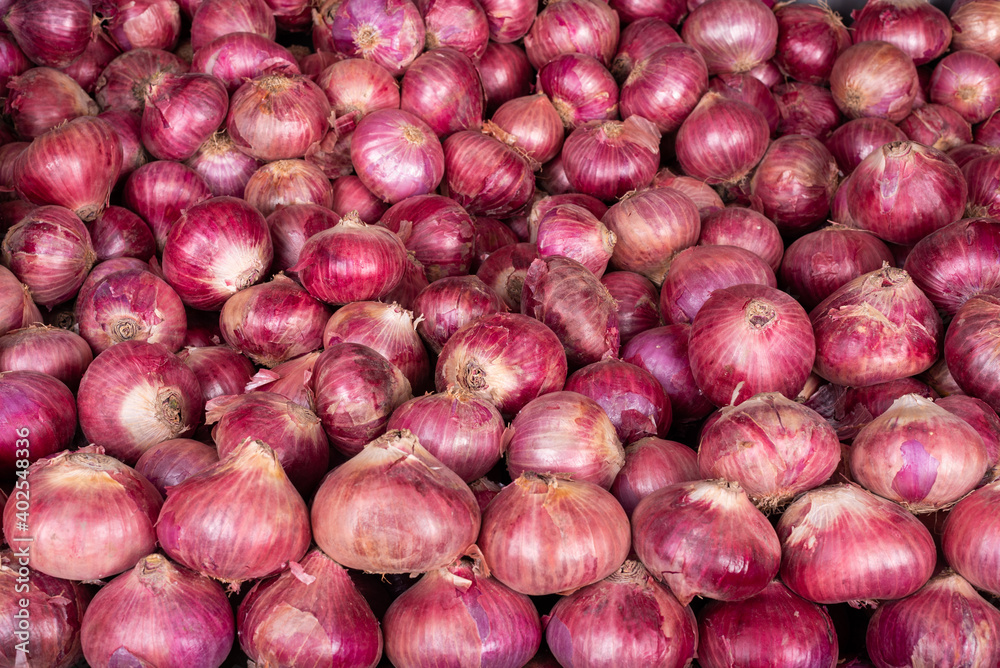 A closeup of Onions in wide range placed in the market A closeup of Onions in wide range placed in the market